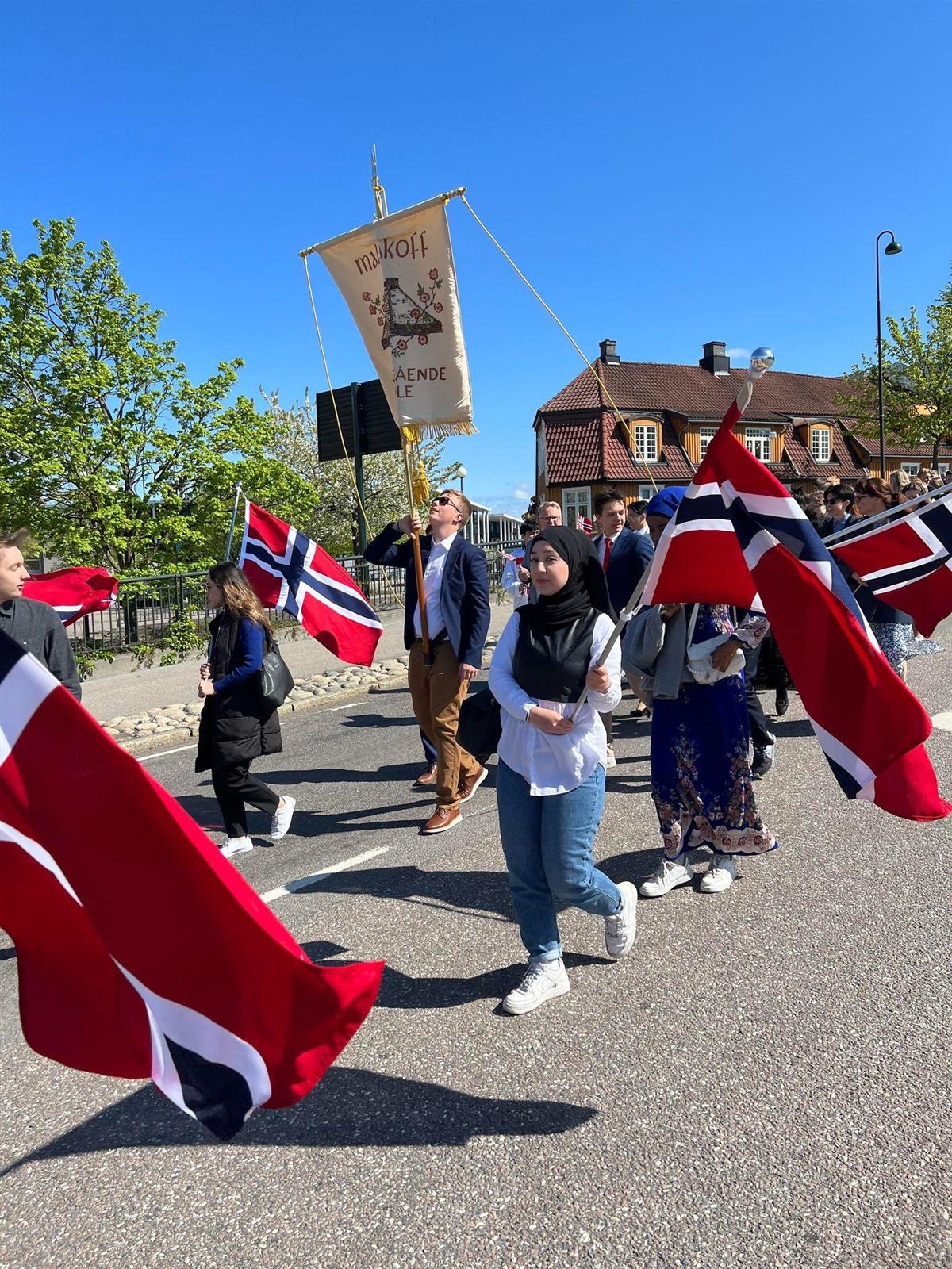 Elever med norske flagg og Fane går i tog. - Klikk for stort bilde
