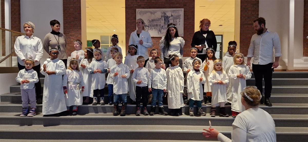 Barnehagebarn er utkledd i hvitt tøy og synger på Luciadagen. - Klikk for stort bilde